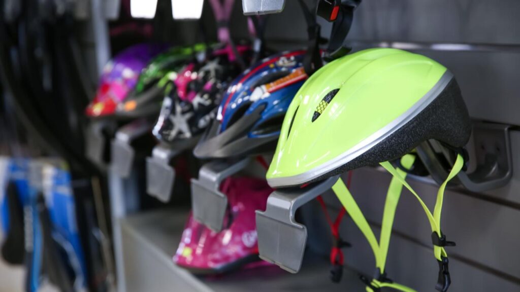 capacete de bicicleta de vários modelos, cores e tamanhos expostos em uma vitrine aberta