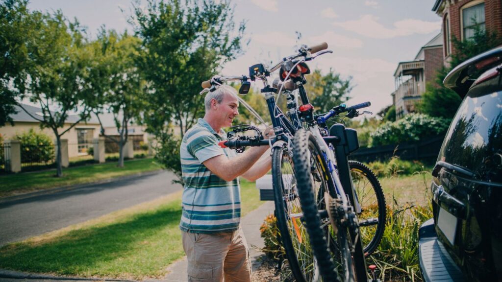 homem guardando a bicicleta no suporte